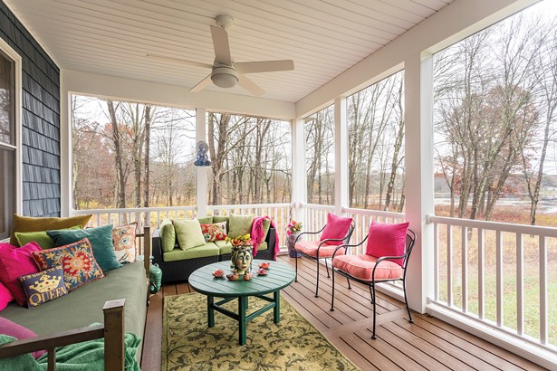 Edwards added a 300-square foot covered porch to the modular home’s original layout, which is often the site of her daily meditation practice. The home features scenic views of Long Pond. - WINONA BARTON-BALLENTINE