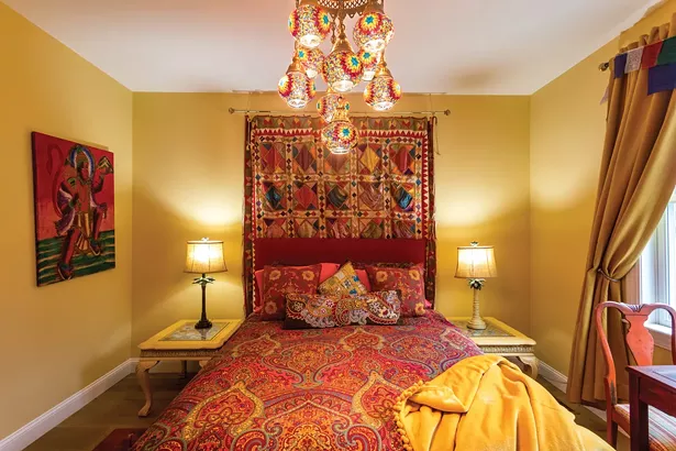 A guest room near the home’s entrance is decorated with textiles and art from Edwards’s travels. The home is roomy enough to accommodate guests—including Edwards's grown sons and grandchildren—without feeling overwhelming. - WINONA BARTON-BALLENTINE