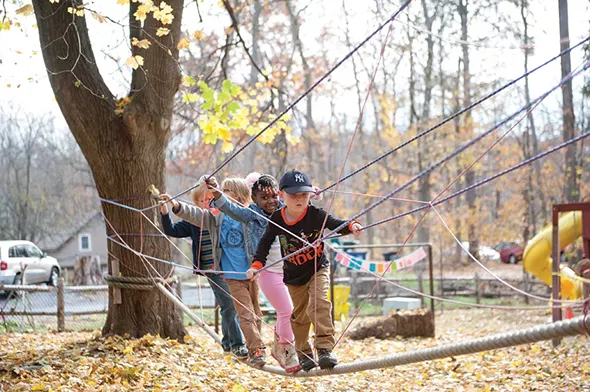 K-1 students climb the obstacle course during Forest Mondays at Randolph School. - HILLARY HARVEY