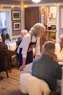 Farmer Carol Clement takes a short break from serving to chat with her guests. - JIM MAXIMOWICZ