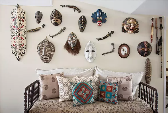 A wall of masks and weaponry collected during Narine's travels. Through her travels, Narine has become adept at thinking on her feet and adapting to whatever culture she's in. "When you travel you are constantly discovering new things about yourself, your strengths, your motivations, and what really inspires you," she says. - DEBORAH DEGRAFFENREID
