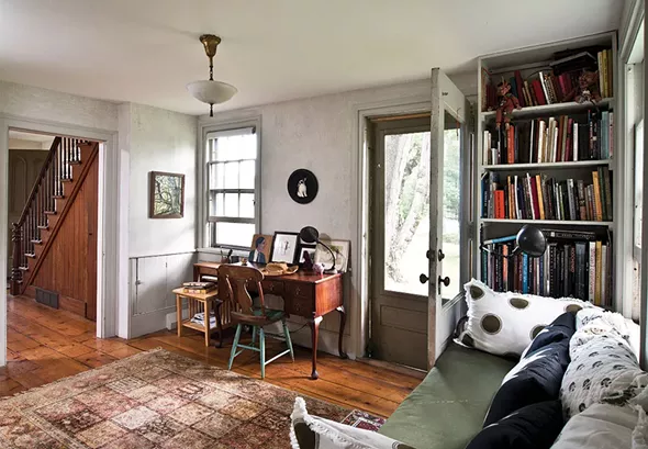 The library and study area of Shaff’s home. True to the spirit of gothic architecture, the home’s ample doors and windows invite the outside in. “One of beauties of being in the woods is affirming your own romantic natural essence—your animal being,” Shaff explains. - DEBORAH DEGRAFFENREID