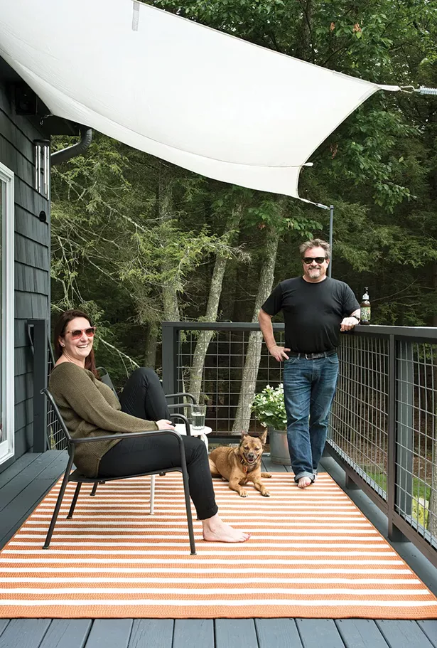 The whole family gathered on the back deck. Decorated with simple awnings and a beer garden table, it’s a popular summer spot. A high powered telescope—a wedding gift from Stenger’s office—helps them take advantage of the dark, upstate nights and keeps them starry-eyed all year long. - DEBORAH DEGRAFFENREID