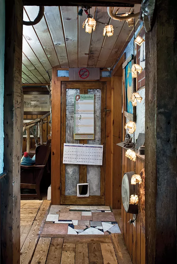 A downstairs hallway. Shaft Perrin’s ceramic tiles line part of the floor. Perrin created various textured finishes for the home’s walls. - DEBORAH DEGRAFFENREID