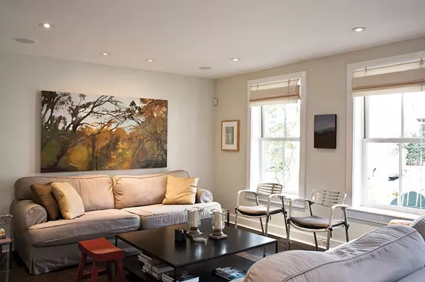 The living room is decorated with a mix of contemporary and antique pieces. “We really tried to keep it anchored in Hudson; the furniture is historic but true to the home’s character,” says Smith. - DEBORAH DEGRAFFENREID