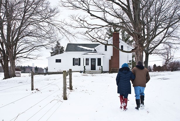 Jamie Cat Callan and Bill Thompson on their Valatie farm. The 19th-century federalist house features the original clapboard siding, and gabled roof with cornices. The original brick chimney and plain window surrounds are also classic features of the period. - DEBORAH DEGRAFFENREID