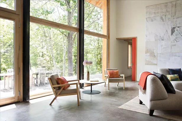 An abundance of south-facing, triple-glazed windows in the double-height living room fills the home with light and capture heat in the winter. They also offer a view of the Shawangunks—bringing the outdoors inside throughout the year. - DEBORAH DEGRAFFENREID