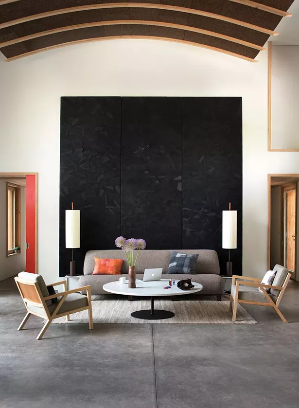 In the living room, Reynolds displays fabric wall art pieces by DesignWork, a zerowaste art project crafted from recycled Eileen Fisher clothing. Eileen Fisher served as a consultant on the project. The home’s arched cork acoustical ceiling was installed by local craftsman Lee Sahler. - DEBORAH DEGRAFFENREID