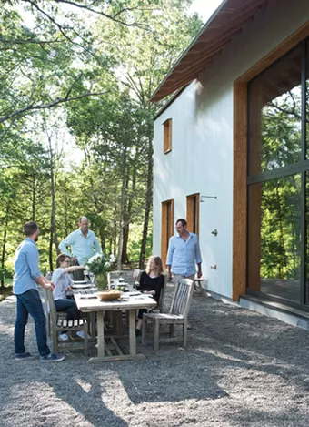 The North River Architecture team enjoys a break outside with Jay Philippi of Eileen Fisher. In keeping with the project’s sustainable design goals, the outdoor patio was landscaped according to xeriscaping principles of native plantings and minimal maintenance. - DEBORAH DEGRAFFENREID