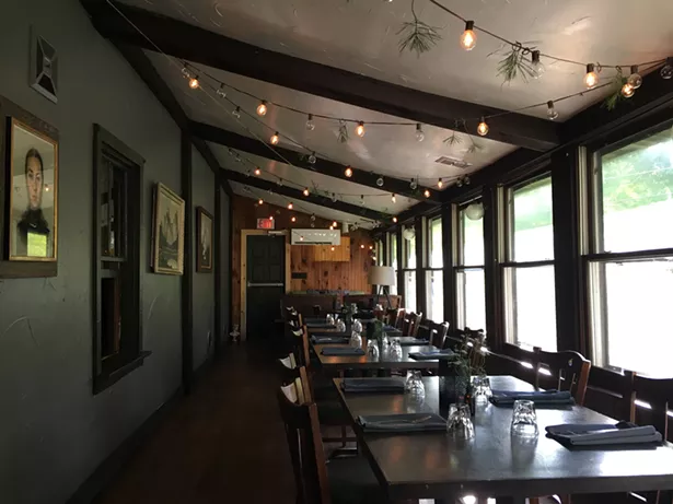 The three-season porch of the house has been converted into a bright, cozy dining area. - MARIE DOYON