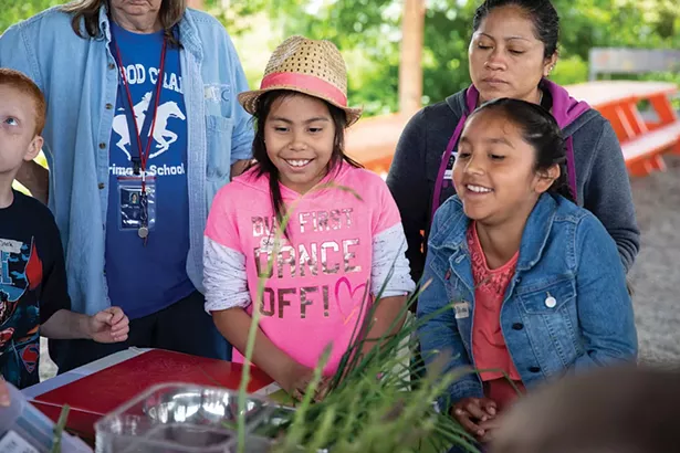 Students from Ichabod Crane Elementary School at Katchkie Farm. After weeding, cultivating garden beds, planting seeds in the greenhouse, and harvesting rhubarb, students worked as a group to prepare green vegetable fried rice and rhubarb applesauce with toasted oats for dessert.