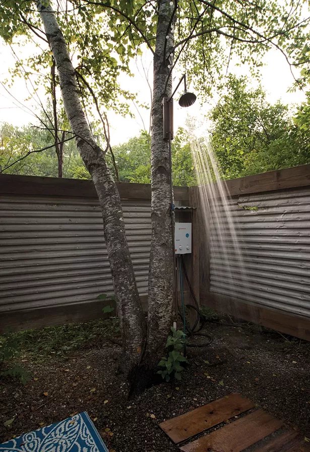Built by Covelli, the outdoor shower features a tankless water heater and wood-and-metal privacy screen. - DEBORAH DEGRAFFENREID