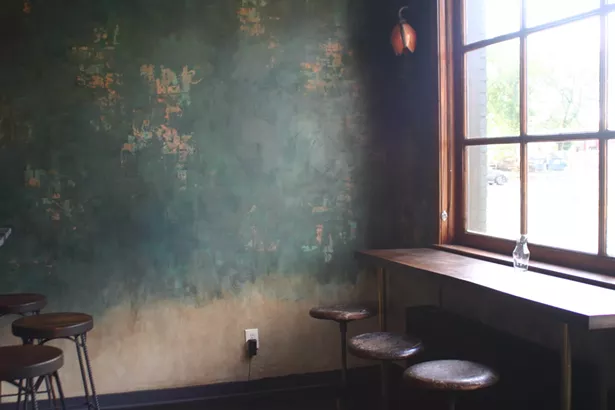 Patty and a friend hand-finished the bar wall to give it a textured, aged look. - MARIE DOYON