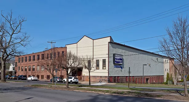 Part of the Fuller Building's exterior was previously covered in vinyl siding.