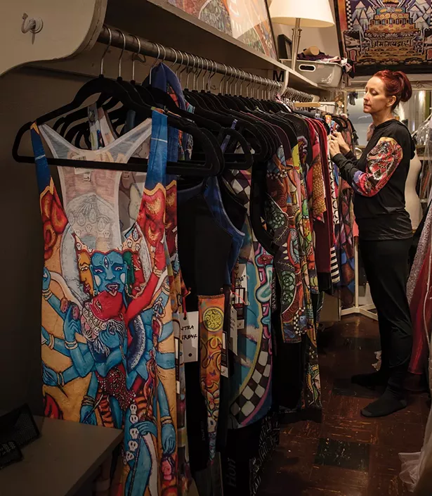 Bickman with some of her 11:11 brand clothing line. Painted with spiritually inspired motifs from her work, the line includes hoodies, yoga pants, tanks and shoes and is manufactured by a woman-run factory. - PHOTO BY DEBORAH DEGRAFFENREID