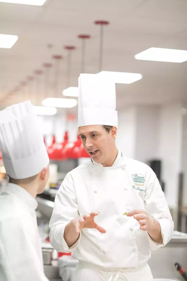 Chef Kaywork and a student in the kitchen, talking history and food. - PHOTO COURTESY OF CIA
