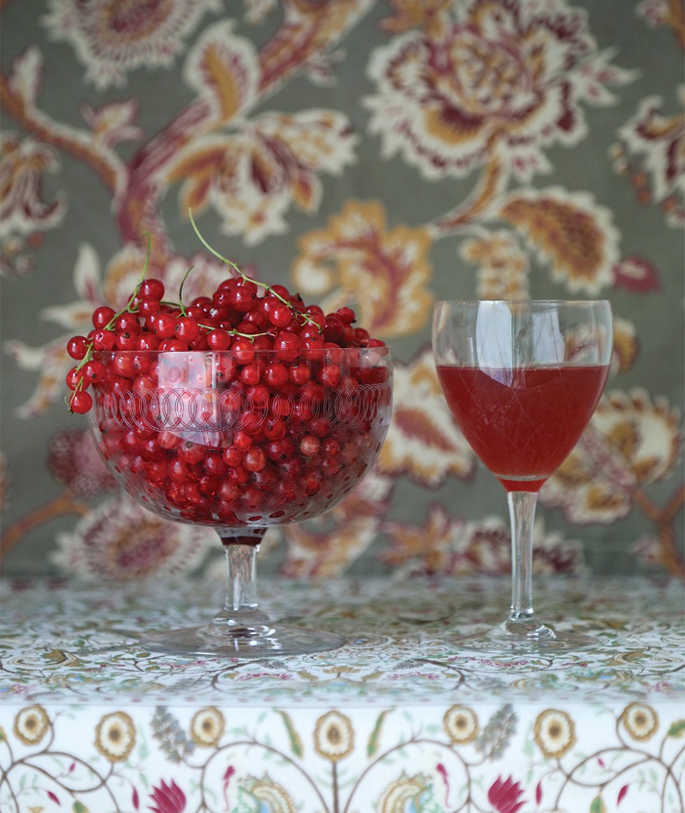Fresh-picked red currants sit aside black currant mead from the previous year. - PHOTO: PETER BARRETT
