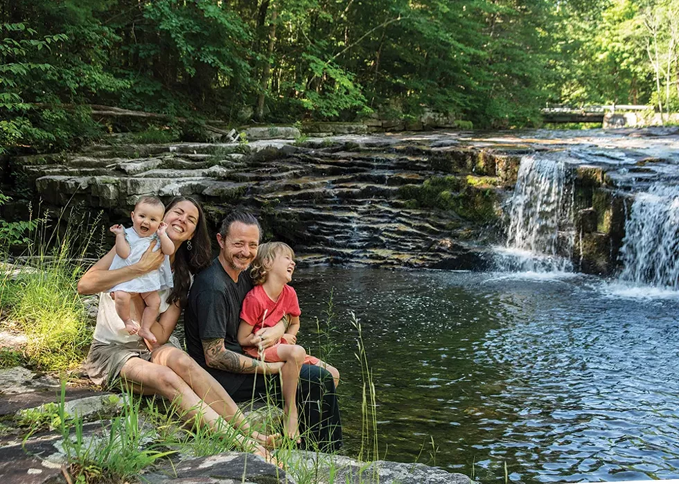 Duncan, Masse, and their two children, Ida and August, by the stream that forms the northern border of their property. - PHOTO: DEBORAH DEGRAFFENREID