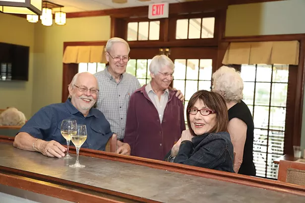 friends catch up at Woodland Pond’s pub.