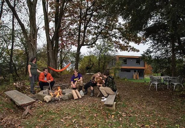 Schmidt, Neiro, and their children at the fire pit and ad-hoc outdoor seating area they created in a grove of trees. “One of the wonderful things about having Sequoia as a partner is that I’ve never had to not have my past,” says Schmidt. “I’ve always had the space to mourn, to acknowledge it, and then to move on. This house has been a chance to create something new and wonderful without having to pretend that 19 years of my life before didn’t exist. This is a really wonderful present and future.” - PHOTO: DEBORAH DEGRAFFENREID