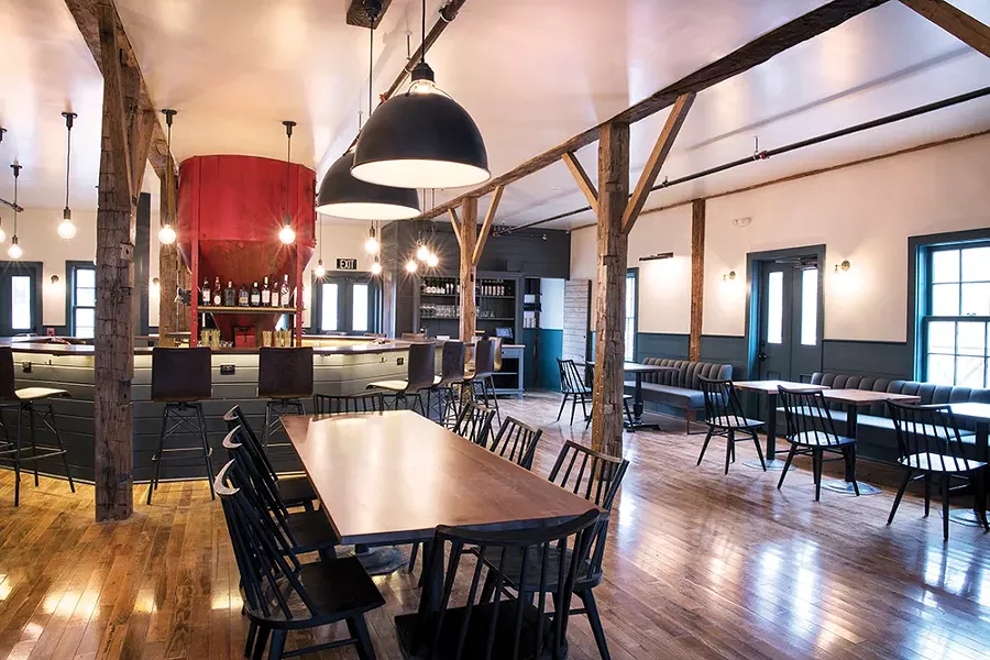 The centerpiece of the bar is a grain hopper, formerly used in the building’s incarnation as a feed store.