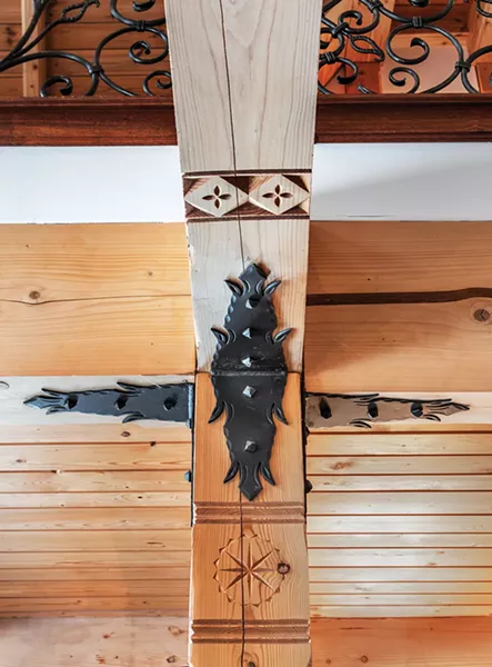 “It’s kind-of a lost art form,” explains Laroux of the detailed, Zakopane wood carvings etched along beams and in corners of the house. The carvings feature various motifs inspired by life in the Tatra mountains. “There are a lot of little details everywhere,” he says. “When you sit long enough, you begin to notice.” - PHOTO BY DEBORAH DEGRAFFENREID