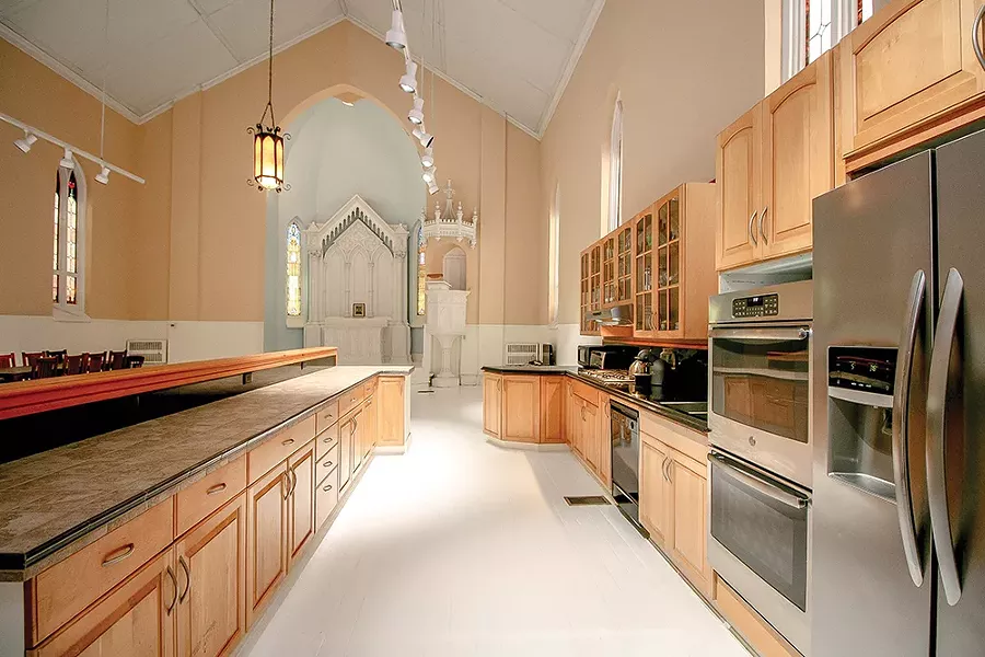 Previous owners added a full kitchen and an island to partially divide it from the former church nave. However, the open space appealed to Bokaer’s aesthetic. “Loft living is dear to me,” he says. “You can trace that aesthetic here to the open plan and the clean, streamlined, minimal design.” - PHOTO BY SETH DAVIS
