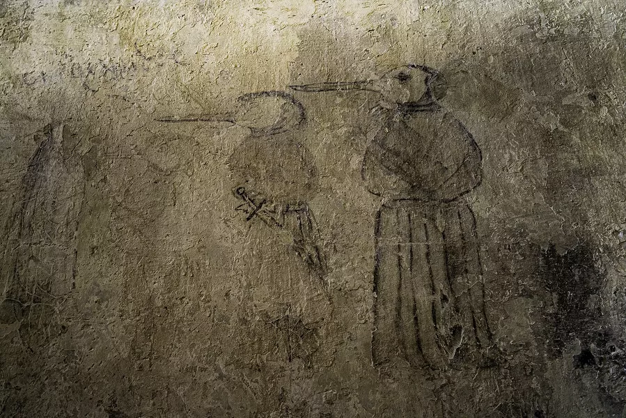Wall drawing of a plague doctor.
