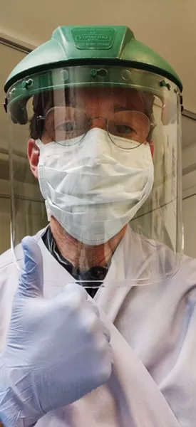 Mark A. Flower, director of Flower Funeral Home in Yonkers wears personal protective equipment while preparing the deceased for funerals. - MARK A. FLOWER