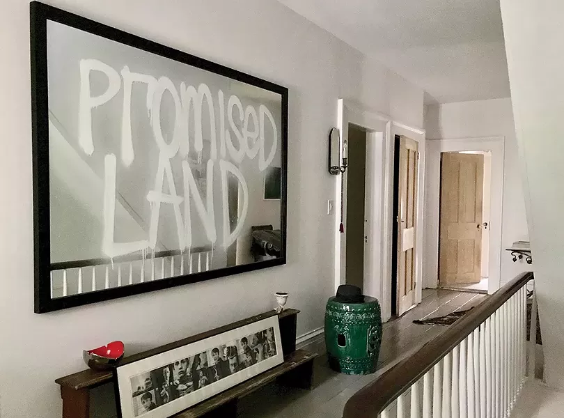 The couple's extensive contemporary art collection includes a number of pieces by Rashid Johnson, whose Promised Land dominates the second-floor hallway landing.