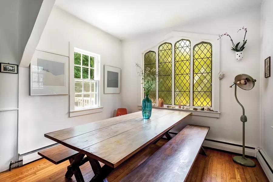 The author bought the dining room table off the former owner, Sturgeon’s widow Marion. The 1960’s dental lamp, a gift from a friend, gives off gentle, painless light. Robert Angeloch prints, - Land and Sea hang on the nook wall. - PHOTO: WINONA BARTON-BALLENTINE
