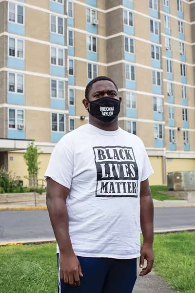 Quintin Cross in front of Bliss Towers, one of the only afforable housing developments in Hudson. - PHOTO BY ANGELINA DREEM