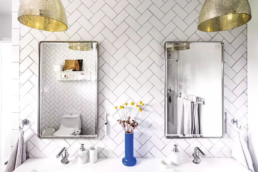Bottom: Schultz and Smyle completely reworked the master bathroom, adding tiles of contrasting colors and textures to the space. At the room’s entrance, black and white Spanish style tiles are a nod to the home’s previous residents, a Spanish couple. “We don’t want to forget the people who lived here before us,” says Schultz. “They were together for such a long time.” - PHOTO BY WINONA BARTON-BALLENTINE
