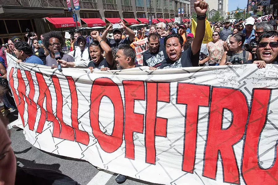 The "Wall Off Trump" demonstrators sprinted down the street while nearly 200 ran alongside in support. The late morning sun was extremely hot and passions rose to a highly pitch, but in the end everyone kept their cool. - FRANK SPINELLI