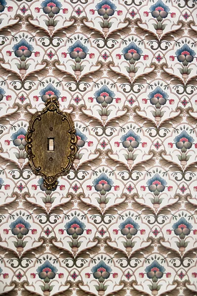 The couple kept the original wallpaper and light switch panel in the upstairs guest room. "This is everyone's favorite room to stay," Sexton says. - DEBORAH DEGRAFFENREID