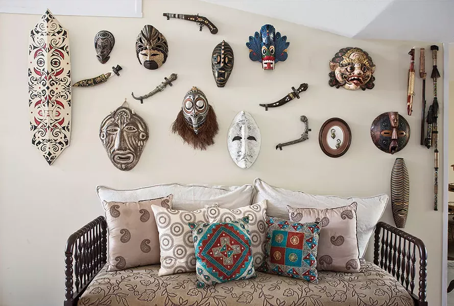 A wall of masks and weaponry collected during Narine's travels. Through her travels, Narine has become adept at thinking on her feet and adapting to whatever culture she's in. "When you travel you are constantly discovering new things about yourself, your strengths, your motivations, and what really inspires you," she says. - DEBORAH DEGRAFFENREID