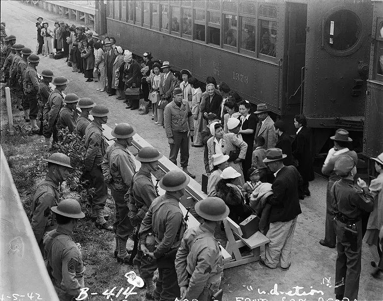 Japanese-Americans arrive under guard at the Santa Anita Assembly Center, April 5, 1942. - CLEM ALBERS