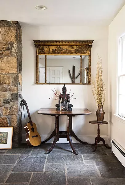 The bluestone-tiled entrance to Susan Coleman's 4,000 square-foot Colonial. Coleman, a mediator who focuses on international conflict resolution, regularly travels the world to help large groups and small negotiate their way towards peace. Her home is decorated with mementos from her journeys. "I'm all about integration," she explains, "and helping people with difficult conversations. When handled in the right way, those difficult conversations can be transformative." - DEBORAH DEGRAFFENREID