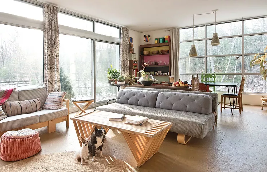 The home’s main living and dining area is flooded with light from the south and west. “Because the home’s interior has a modern loft/gallery feeling to me, especially when we first completed it, I finally had a clean slate to display the furniture, art, and objects I’d spent my early adult years collecting,” Bissell explains. Tina and Angus sit patiently. - DEBORAH DEGRAFFENREID