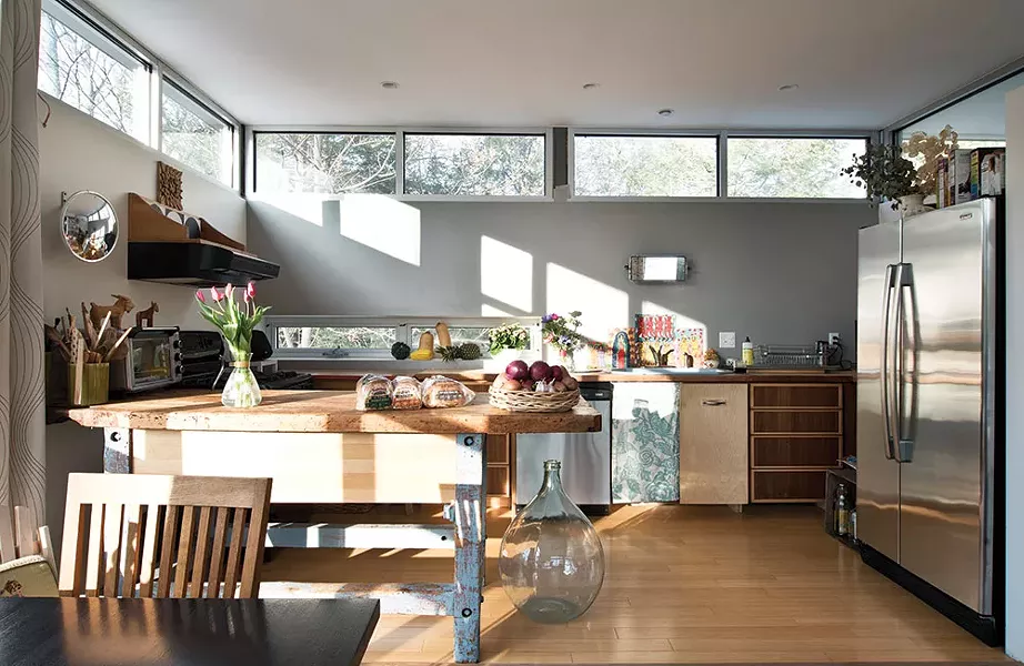 The home’s kitchen was completed on a shoestring budget. Mismatched cabinets and pine butcher block counters complement a blue discounted sink from N&S Supply in Kingston. “Most everything is hand-me-down or from yard sales,” Bissell says. “That’s how we roll.” - DEBORAH DEGRAFFENREID