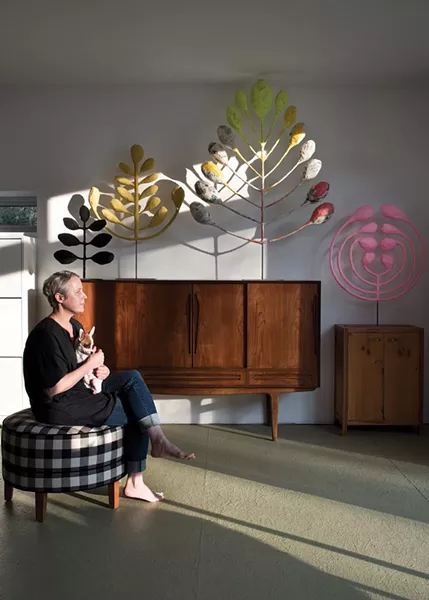 Zoe Bissell in the master bedroom of her kit home, surrounded by some of her most recent work. Her bold and playful metal-and-papier-mâché sculptures begin as sketches. After Bissell settles on a shape she likes, she casts a metal armature in her shop and then adds the papier-mâché and paints. “They are quirky and crude and not meant to be precious at all,” Bissell explains. “A lot of my work is not at all meant to be permanent.” - DEBORAH DEGRAFFENREID