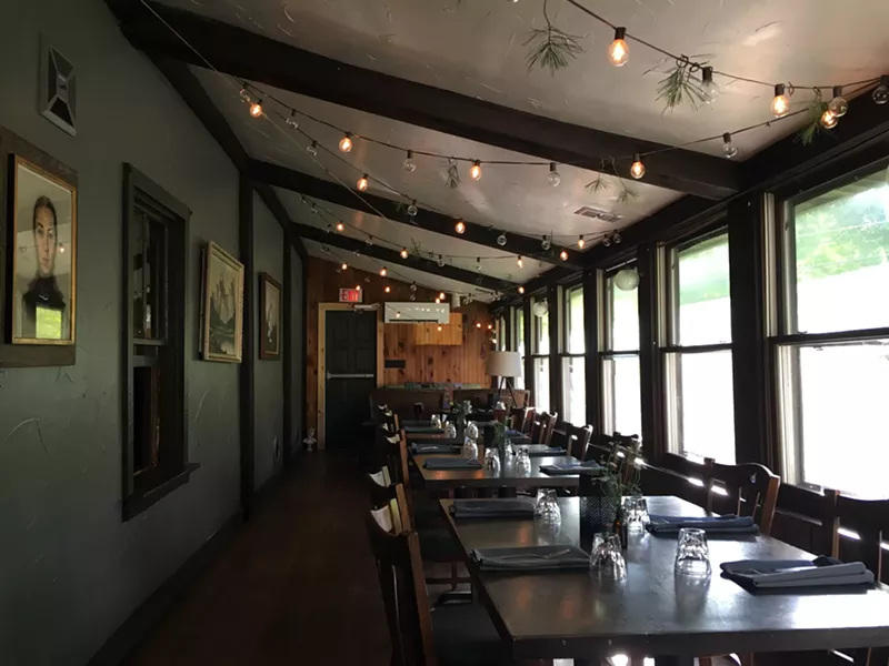 The three-season porch of the house has been converted into a bright, cozy dining area. - MARIE DOYON