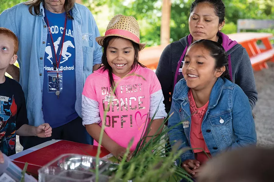 Students from Ichabod Crane Elementary School at Katchkie Farm. After weeding, cultivating garden beds, planting seeds in the greenhouse, and harvesting rhubarb, students worked as a group to prepare green vegetable fried rice and rhubarb applesauce with toasted oats for dessert.