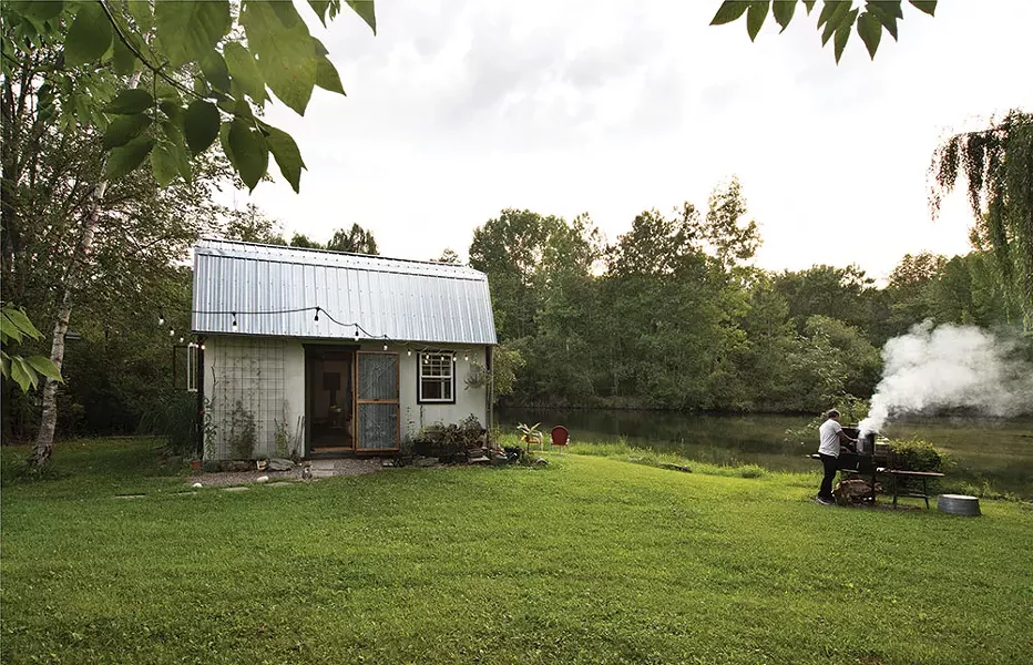 The exterior of the studio shed with Covelli at the BBQ. “I would like someone to monetize the sweat equity we›ve put out into the world, over the past 20 years,” he says. - DEBORAH DEGRAFFENREID