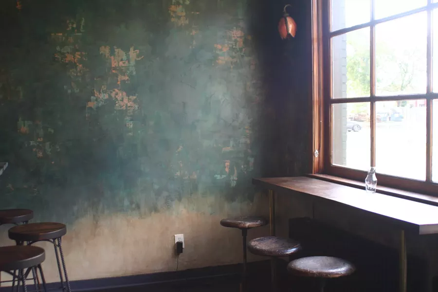 Patty and a friend hand-finished the bar wall to give it a textured, aged look. - MARIE DOYON