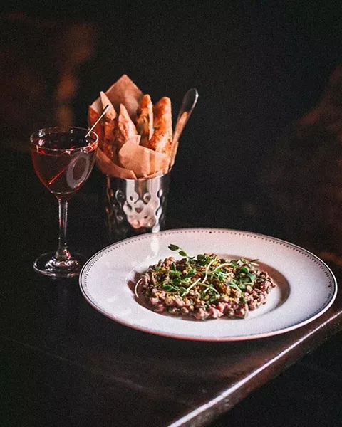 The perfect Manhattan cocktail & Steak Tartare, with pickled green beans & cured egg yolk, at the Maker Lounge. - COURTESY OF THE MAKER