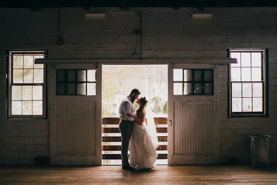 The couple steals a moment in the Creekside Studio. - JOSHUA BROWN PHOTOGRAPHY, COURTESY OF LUMBERYARD