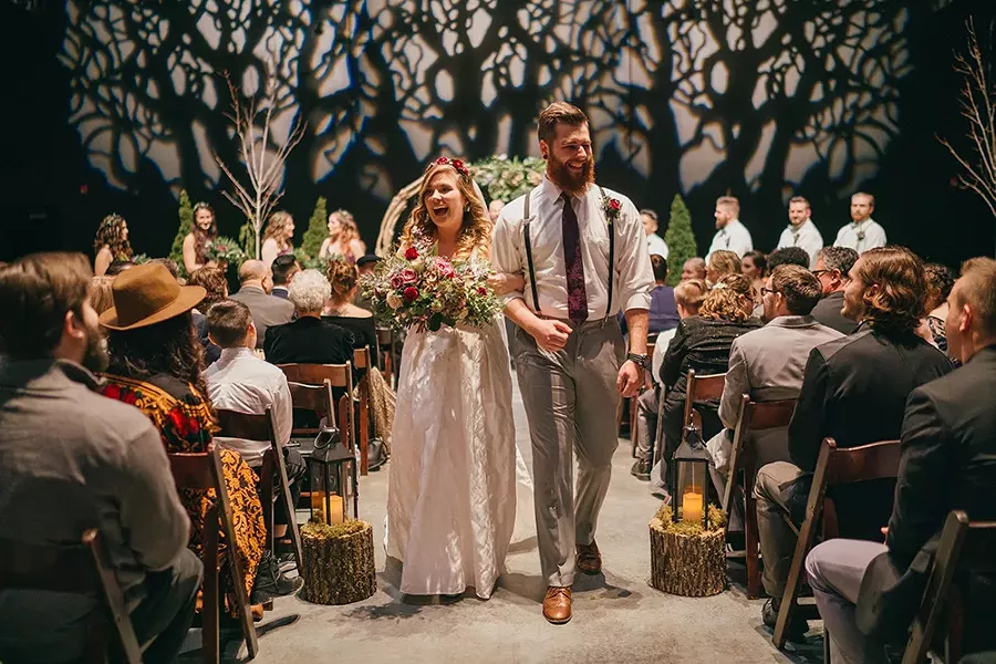 The newlyweds exit the ceremony in the Theater/Ballroom. - JOSHUA BROWN PHOTOGRAPHY, COURTESY OF LUMBERYARD