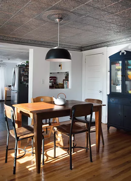 The home’s back dining room was part of an addition made in the 1920s. Rodabaugh keeps her extensive collection of Pyrex crockery in a corner hutch. “My brother used to have a side business in antiques and I always loved Pyrex. Every holiday or birthday he would get me a new piece,” she says.