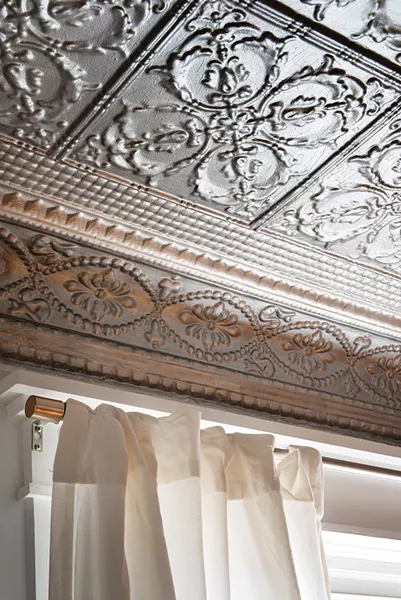The couple elected to keep the home’s tin ceilings their original colors, providing contrast to the white walls.